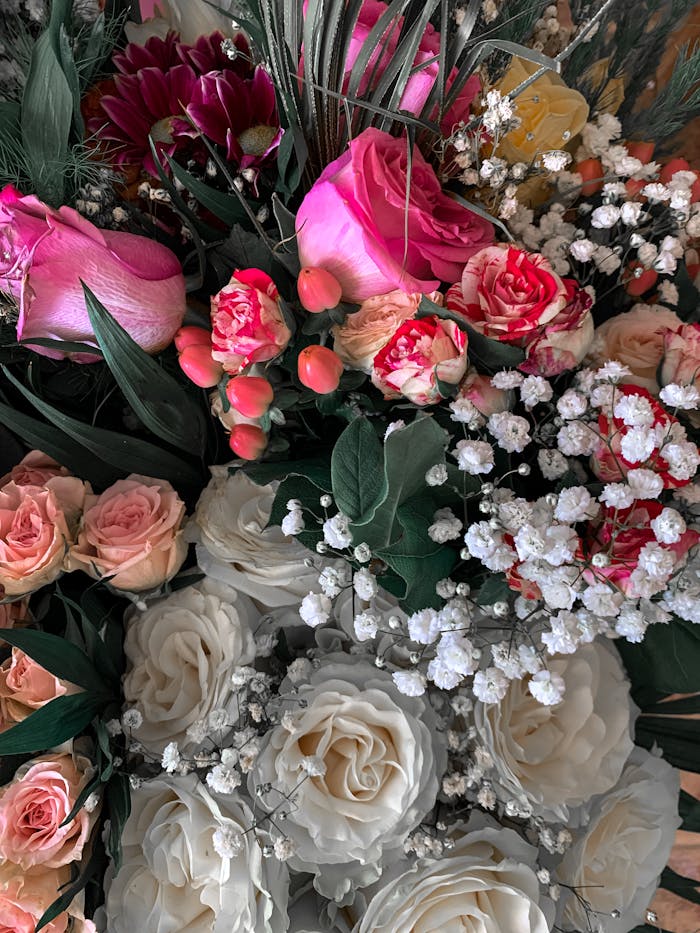 services-02 Close-up of a colorful arrangement featuring roses and delicate baby's breath.