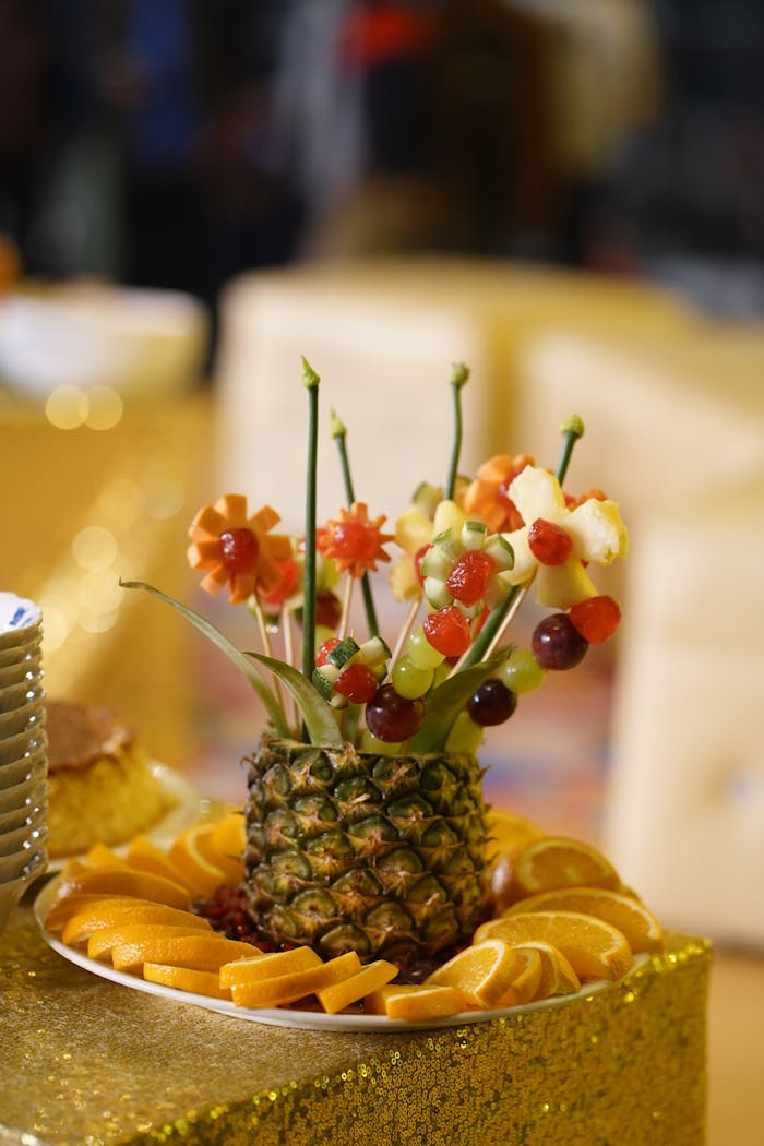 gallery-2 Vibrant fruit bouquet in a pineapple base with fresh orange slices, ideal for festive celebrations.